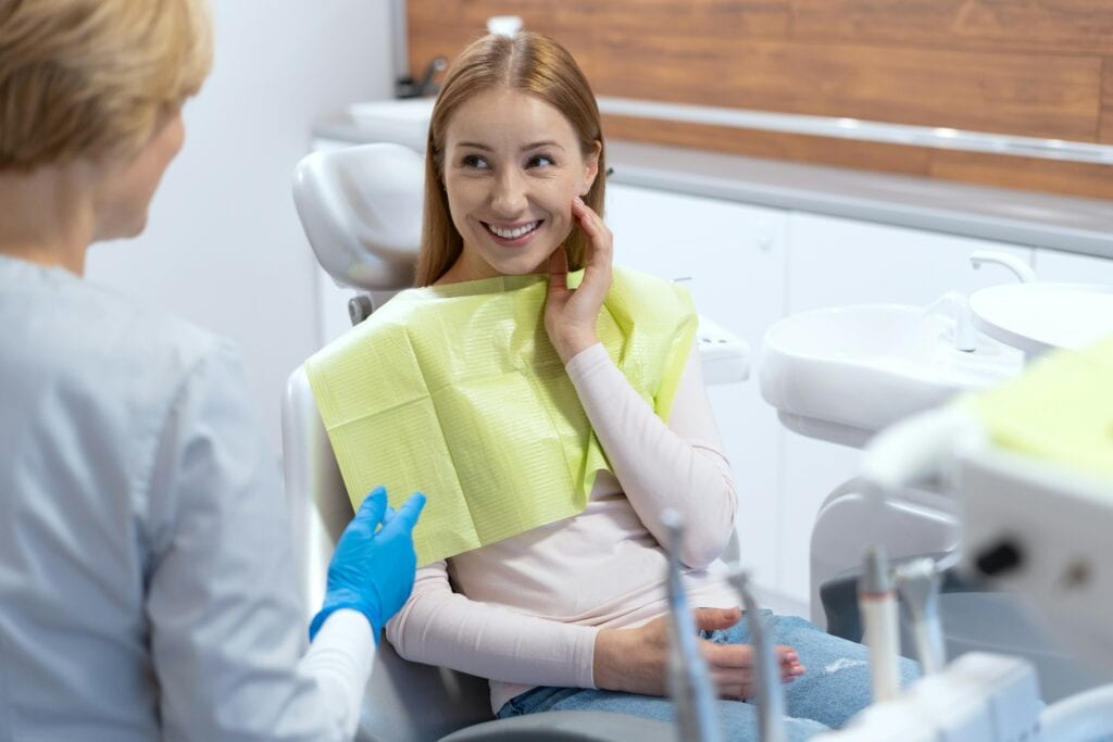 Smiling female patient in a dental chair