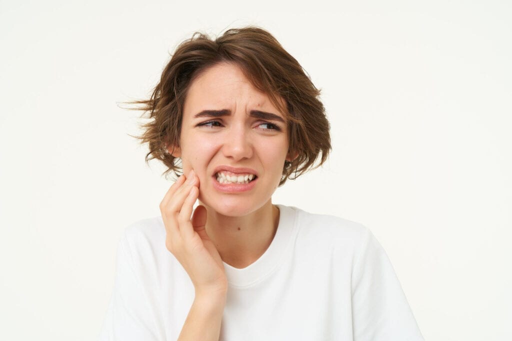Woman holding her cheek
