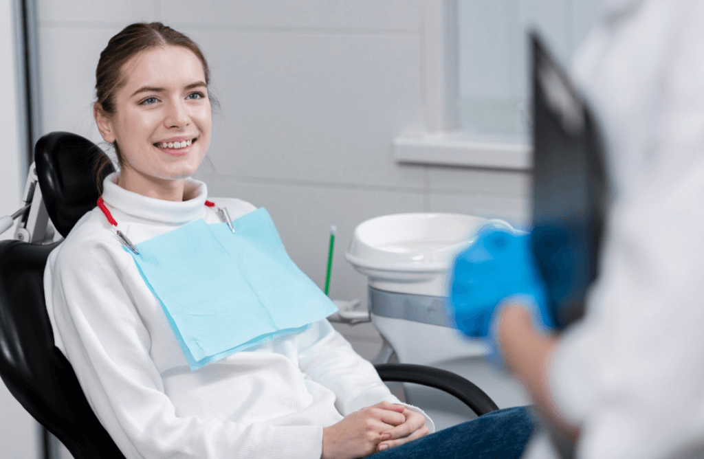Smiling young woman sitting in a dental chair