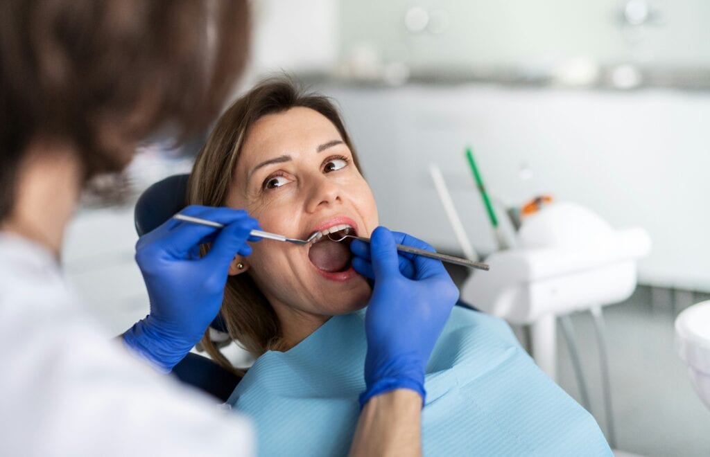 Female patient with open mouth in a dental chair