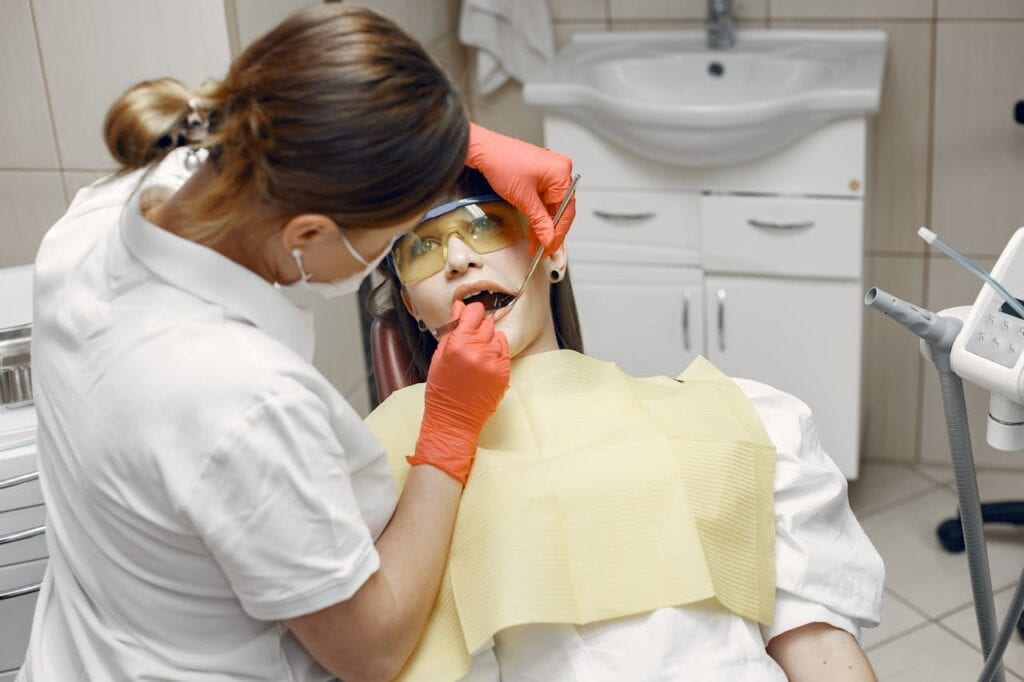 Dentist carefully examining a relaxed patient