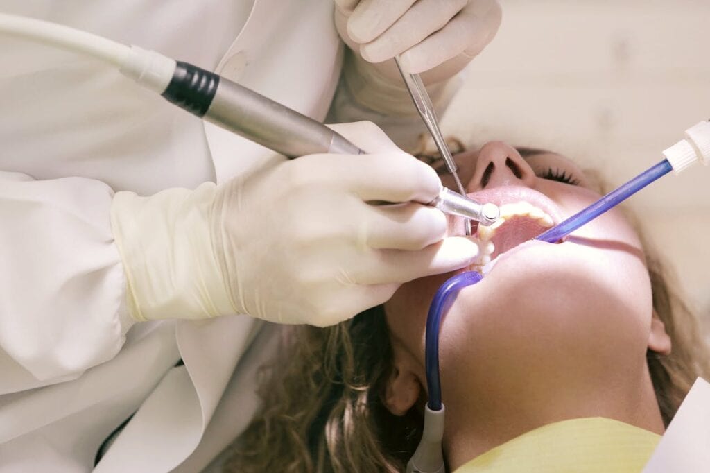 Dentist performing a dental procedure on a relaxed patient using oral conscious sedation